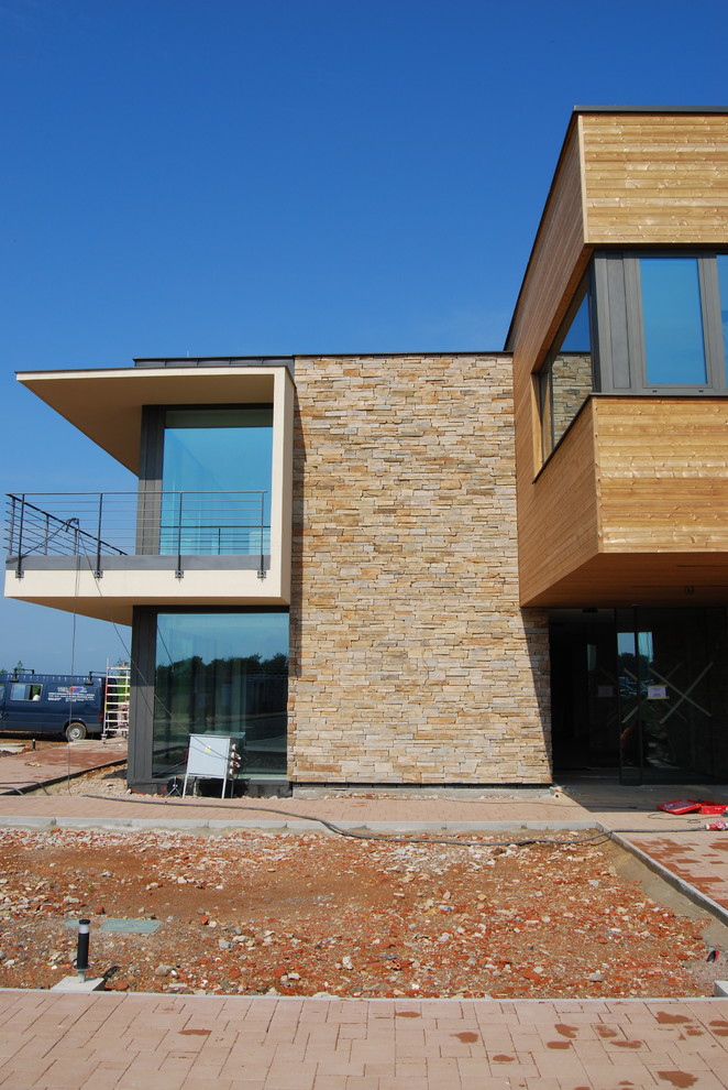 Huge trendy two-story stone exterior home photo in Santa Barbara