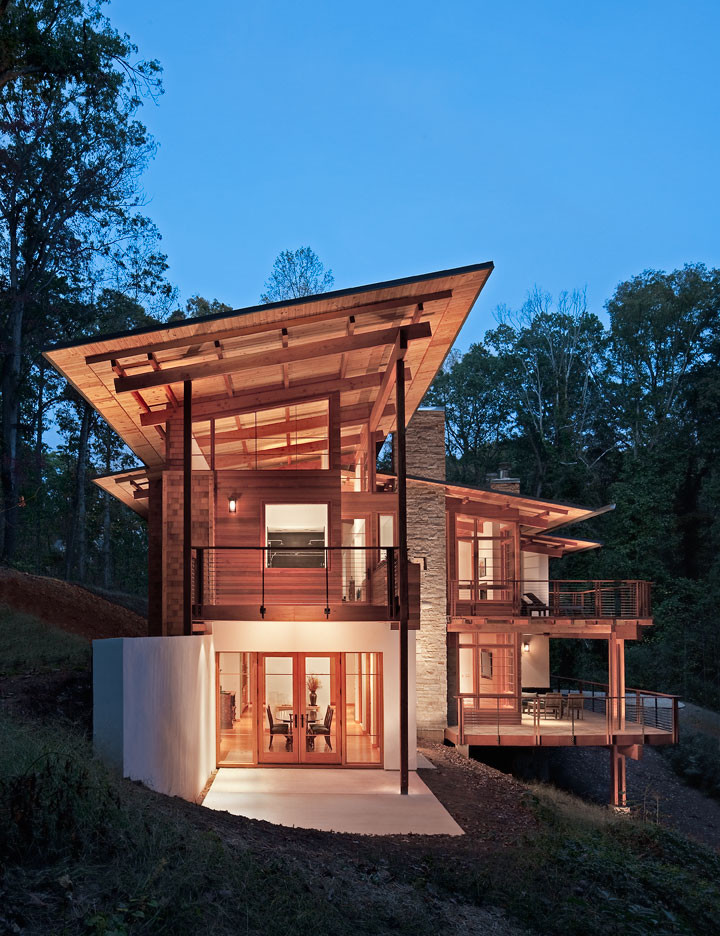 Expansive and brown contemporary house exterior in Atlanta with three floors, mixed cladding and a lean-to roof.