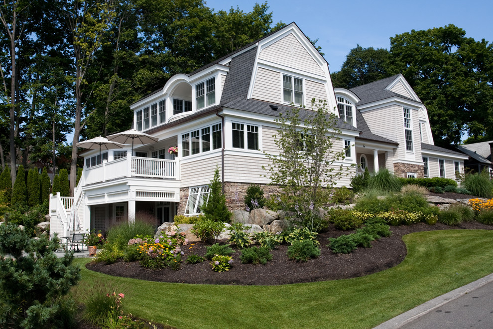 Example of a large beach style white three-story wood exterior home design in Boston