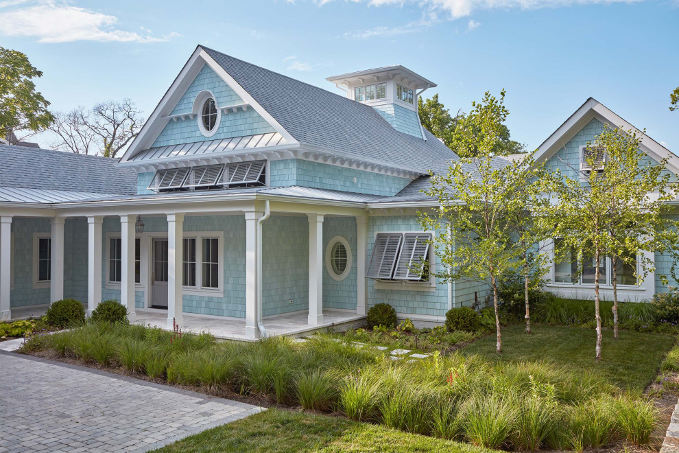 Example of a large beach style blue two-story house exterior design in Baltimore