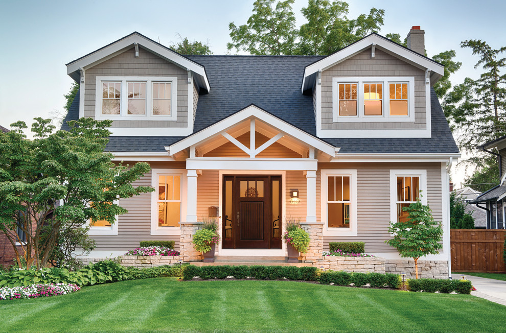 Photo of a medium sized and beige traditional two floor house exterior in Minneapolis with concrete fibreboard cladding and a pitched roof.