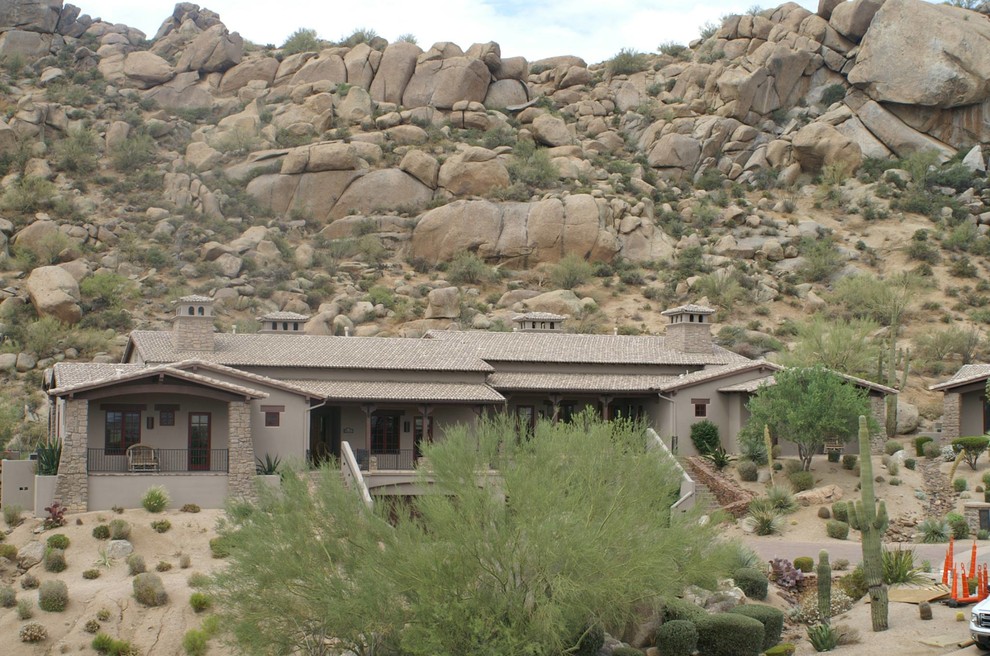 Example of a large southwest gray two-story stucco exterior home design in Phoenix with a hip roof