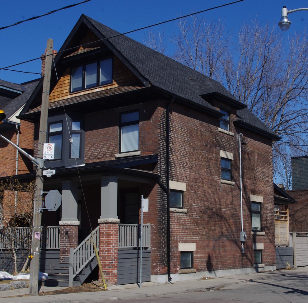 Inspiration for a mid-sized transitional gray three-story brick exterior home remodel in Toronto