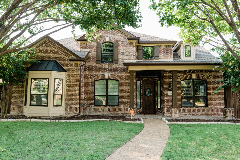 Inspiration for a large transitional two-story brick exterior home remodel in Dallas with a shingle roof