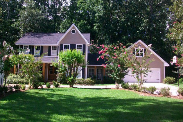 Inspiration for a small transitional beige two-story vinyl exterior home remodel in Jackson
