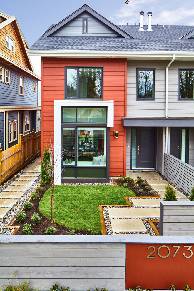 Medium sized and gey contemporary house exterior in Vancouver with three floors.