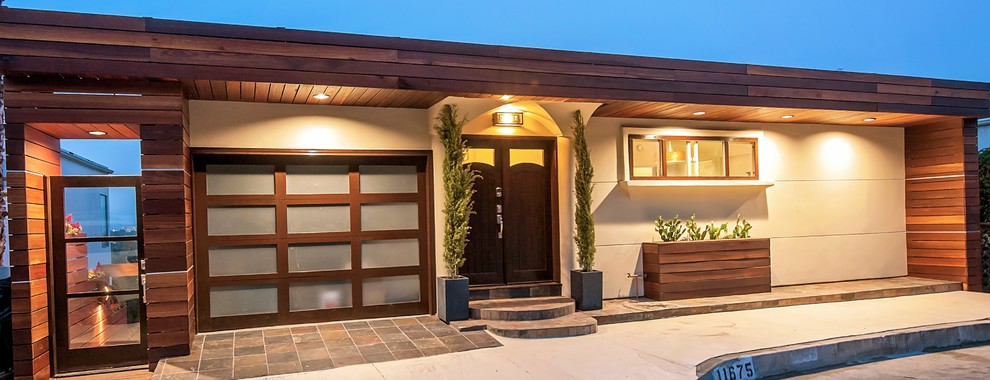 Photo of a medium sized and brown modern two floor house exterior in Los Angeles with wood cladding and a flat roof.