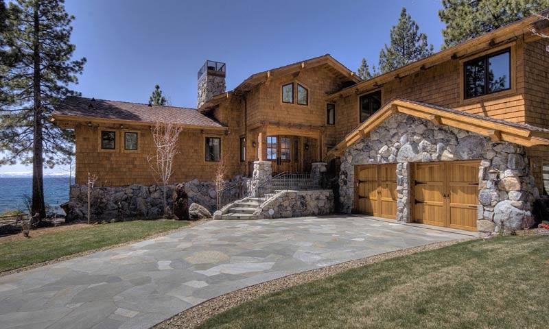 Example of a large mountain style brown two-story wood exterior home design in Sacramento with a clipped gable roof