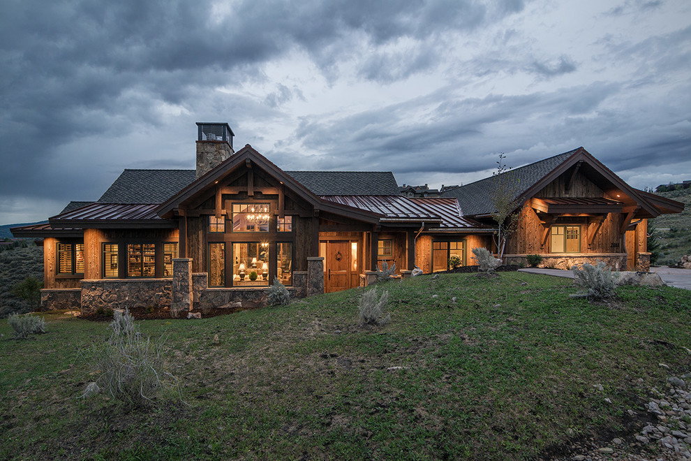 This is an example of a brown and large rustic two floor house exterior in Salt Lake City with wood cladding and a pitched roof.