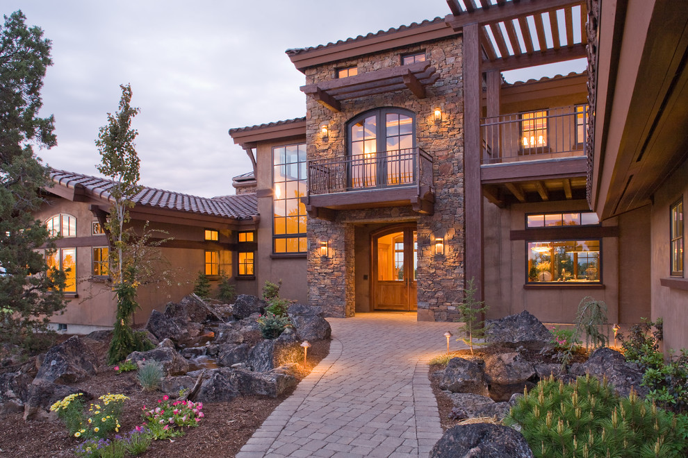 Inspiration for a mediterranean brown two-story stucco exterior home remodel in Portland