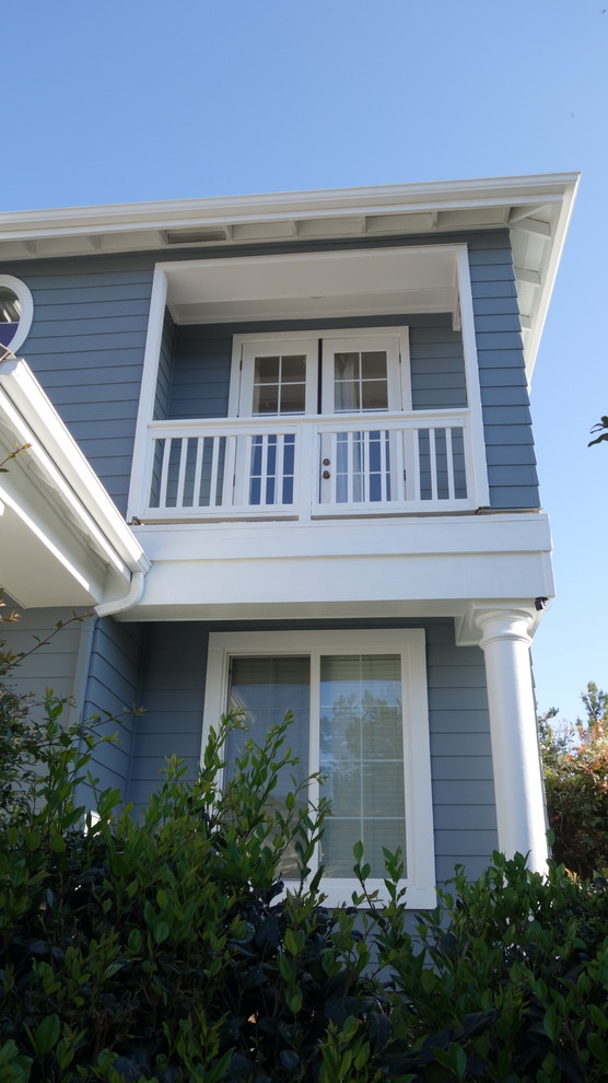 This is an example of an expansive and blue traditional two floor house exterior in San Diego with mixed cladding.