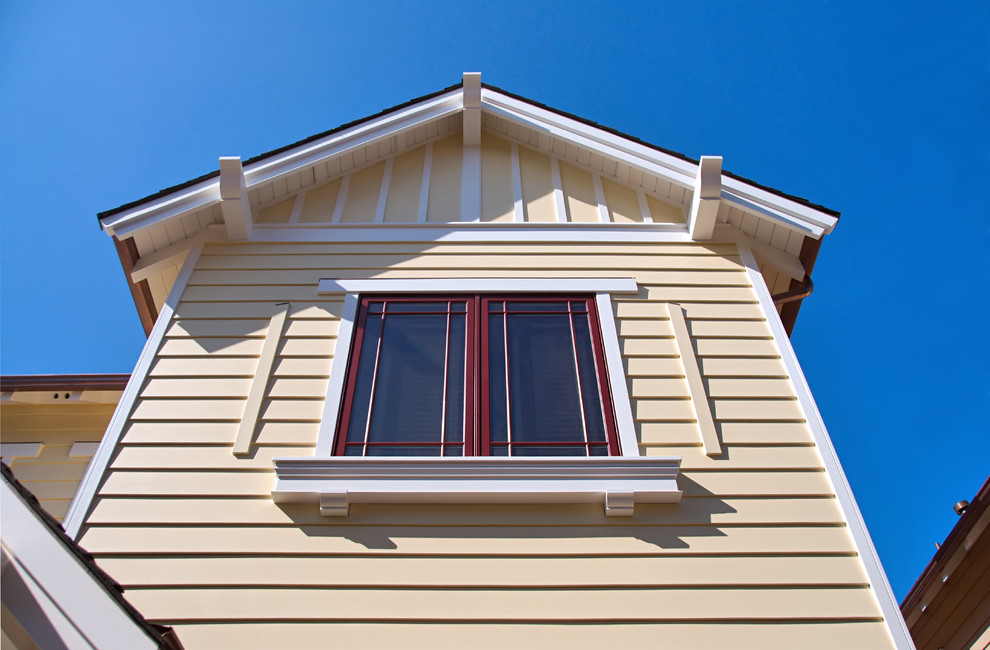 Esempio della facciata di una casa a schiera grande beige contemporanea a due piani con rivestimento in legno e copertura a scandole