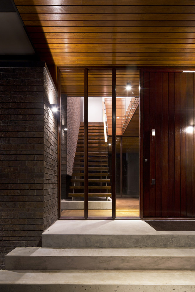 Inspiration for a contemporary brown brick exterior home remodel in Sydney