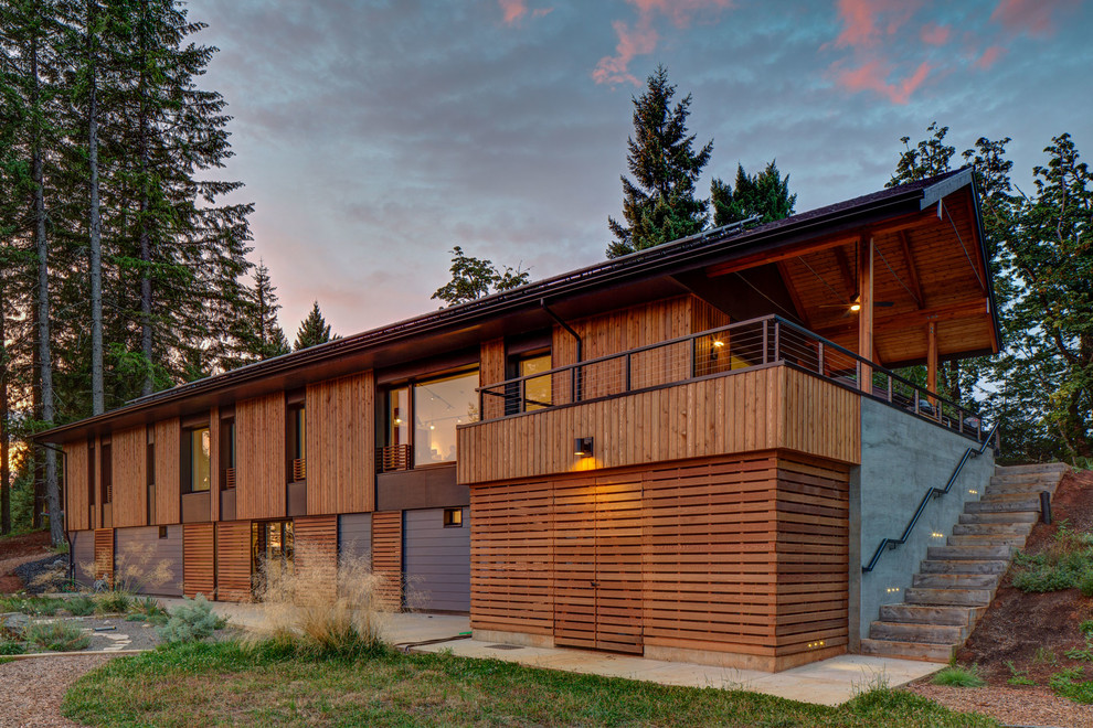 Photo of a contemporary two floor house exterior in Portland with wood cladding and a pitched roof.