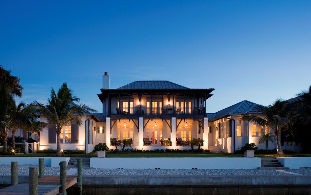 Example of a large island style two-story exterior home design in Tampa