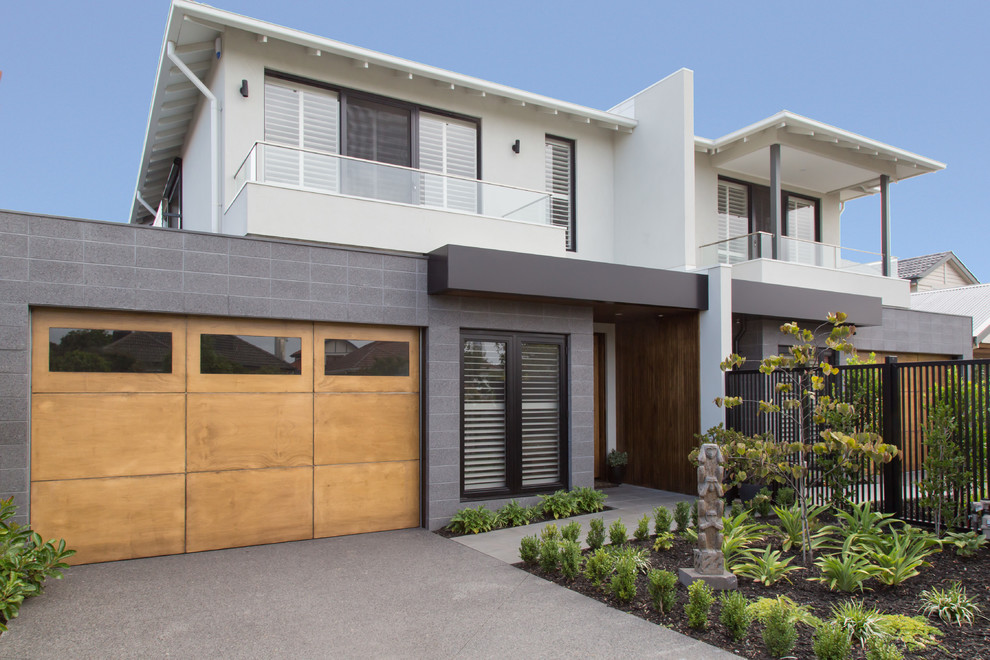Mittelgroßes, Zweistöckiges Modernes Einfamilienhaus mit Betonfassade, grauer Fassadenfarbe, Flachdach und Blechdach in Melbourne