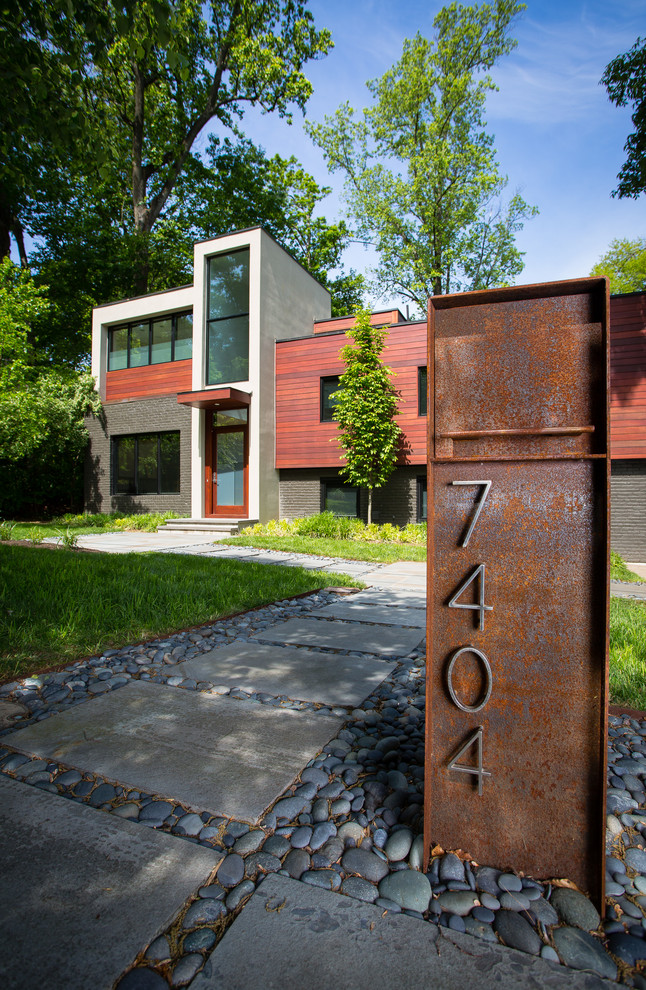 Large and brown contemporary two floor detached house in DC Metro with mixed cladding and a flat roof.