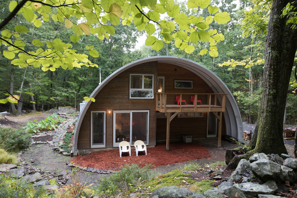 This is an example of a medium sized modern two floor detached house in New York with metal cladding and a metal roof.