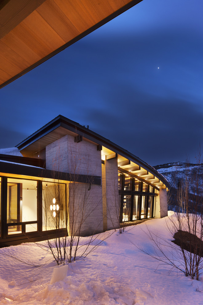 Inspiration for a large modern gray one-story stone house exterior remodel in Salt Lake City