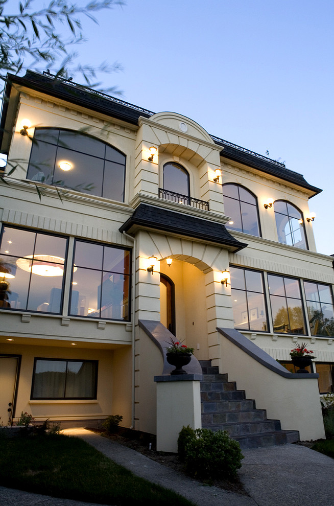 Inspiration for a timeless yellow three-story stucco exterior home remodel in Seattle