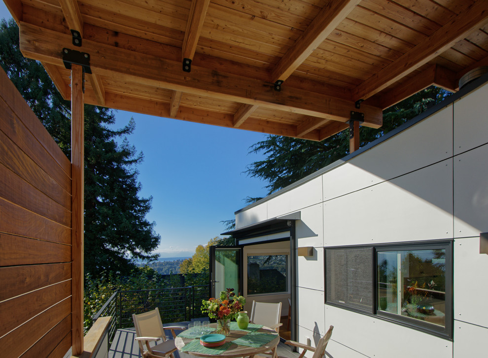 Example of a mid-sized trendy white two-story concrete fiberboard exterior home design in Seattle