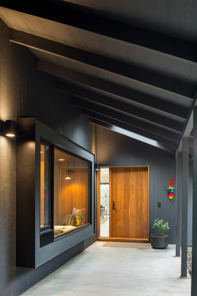 Inspiration for a mid-sized mid-century modern black one-story wood exterior home remodel in Portland with a metal roof