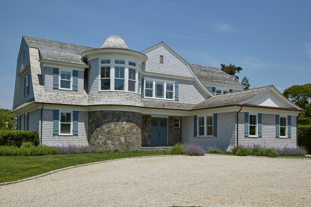 Inspiration for a coastal two-story mixed siding house exterior remodel in New York with a gambrel roof and a shingle roof