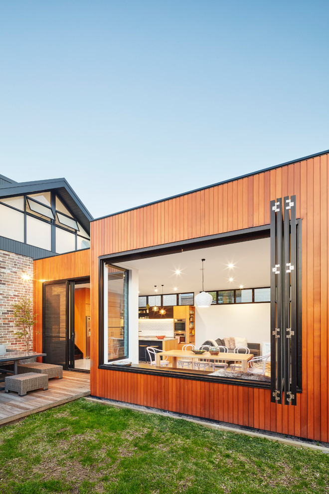 Mid-sized trendy two-story wood exterior home photo in Sydney with a metal roof