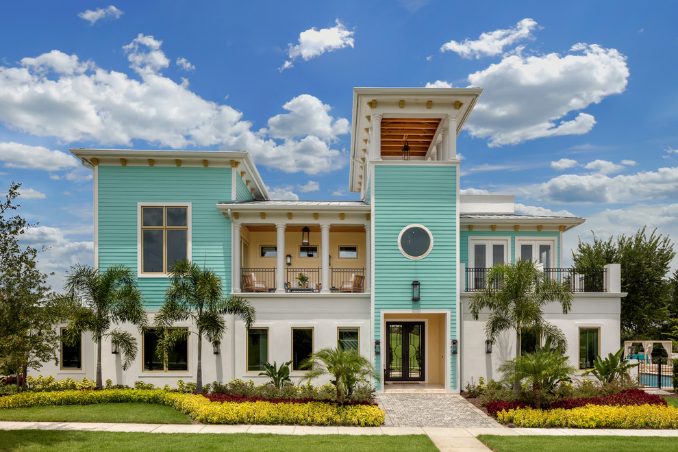Coastal multicolored two-story mixed siding house exterior idea in Orlando with a hip roof