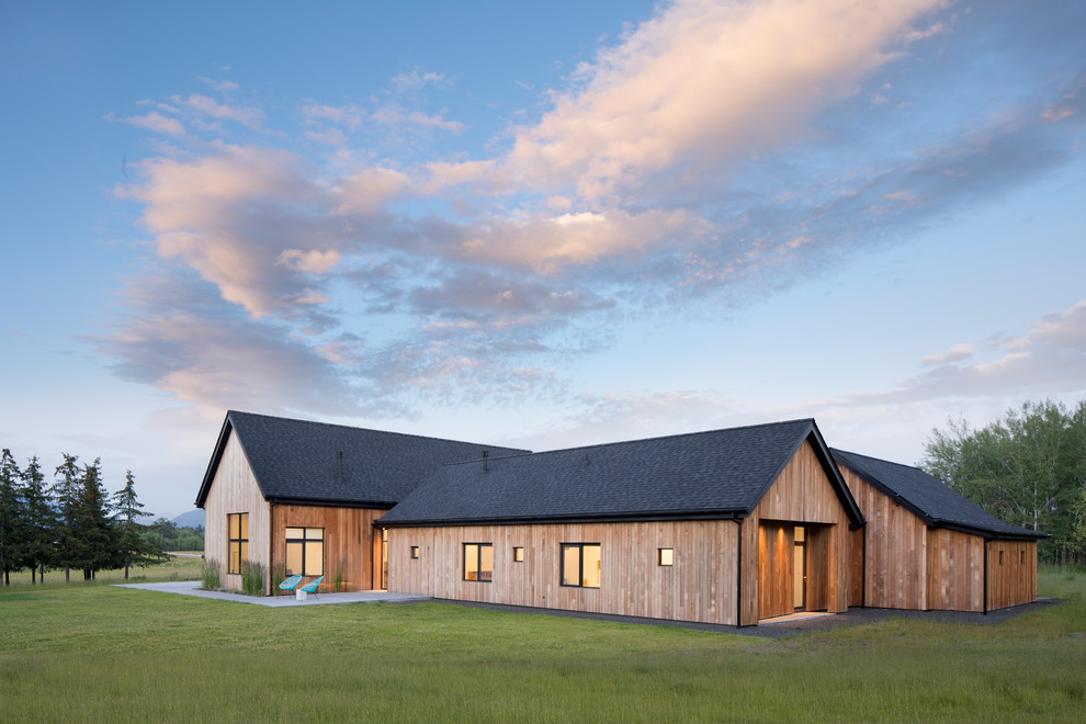 Réalisation d'une grande façade de maison marron nordique en bois de plain-pied avec un toit à deux pans et un toit en shingle.