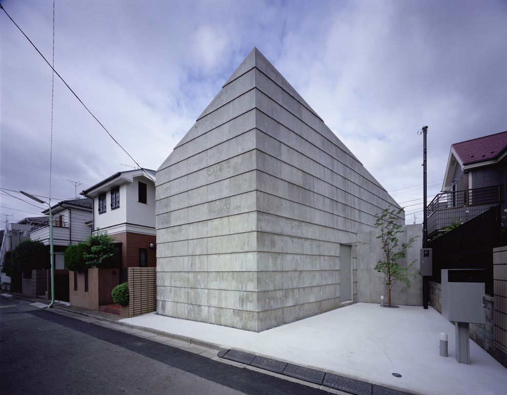 Immagine della facciata di una casa contemporanea con rivestimento in cemento