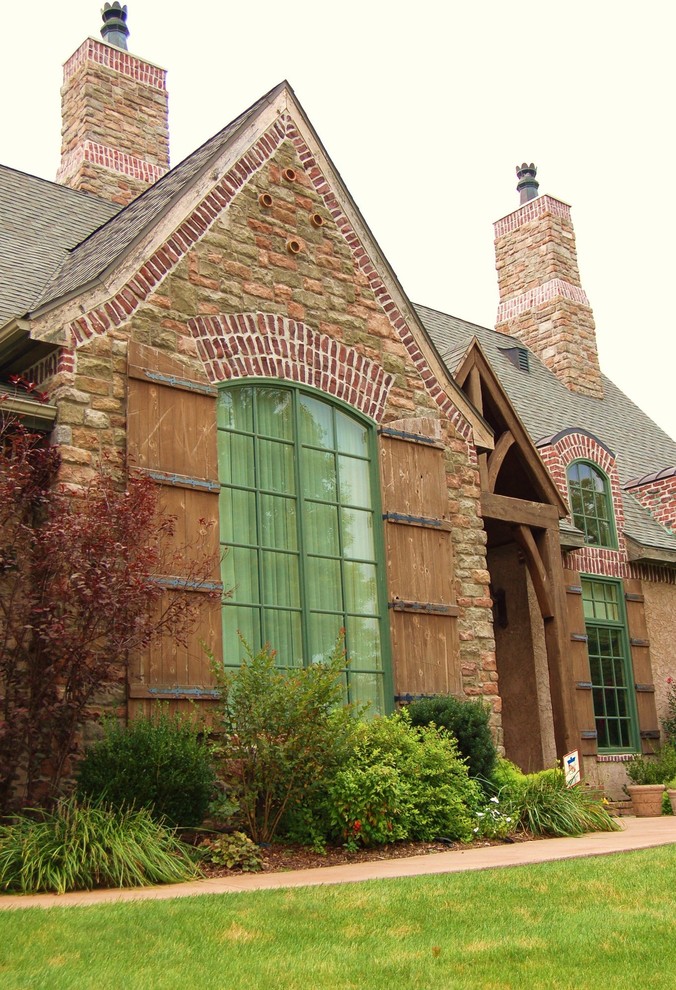 Inspiration for a large and red traditional two floor brick house exterior in Other.