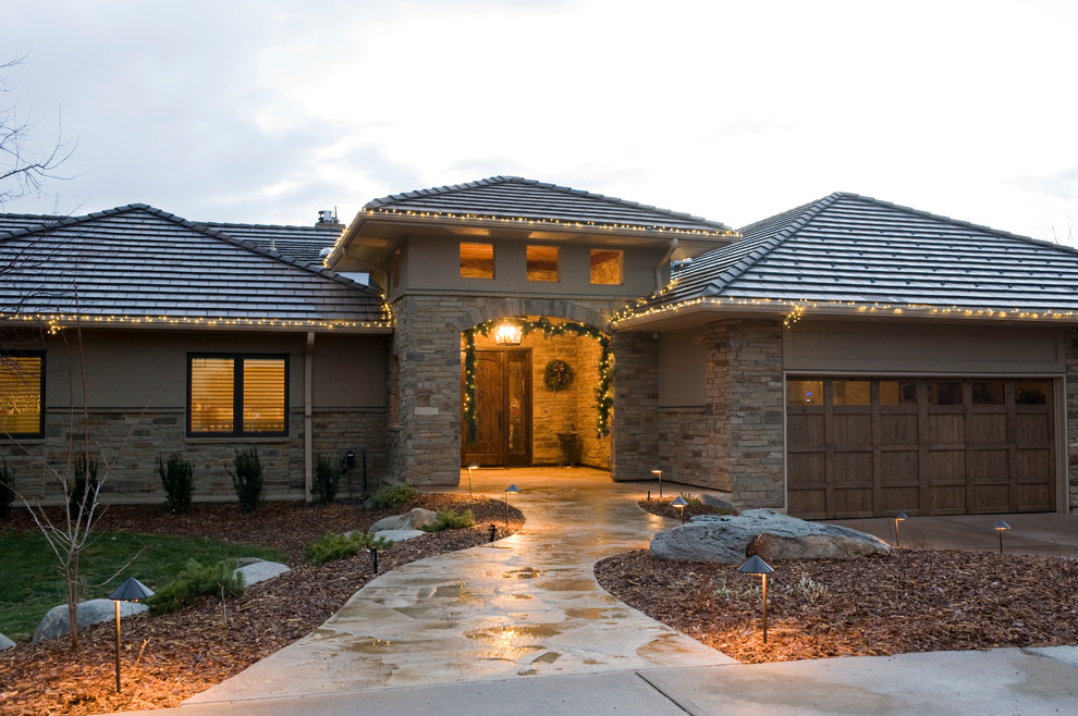This is an example of a medium sized and beige classic bungalow detached house in Denver with stone cladding, a mansard roof and a tiled roof.