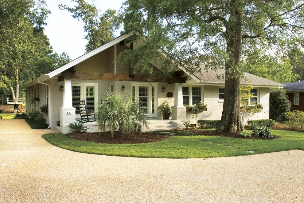 Example of an arts and crafts brick gable roof design in Other