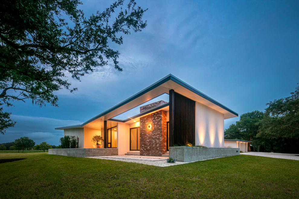 Inspiration for a medium sized and white contemporary bungalow brick detached house in Tampa with a metal roof.
