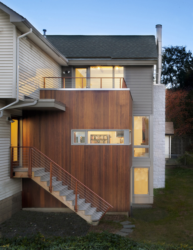 Medium sized and gey contemporary house exterior in DC Metro with three floors and mixed cladding.
