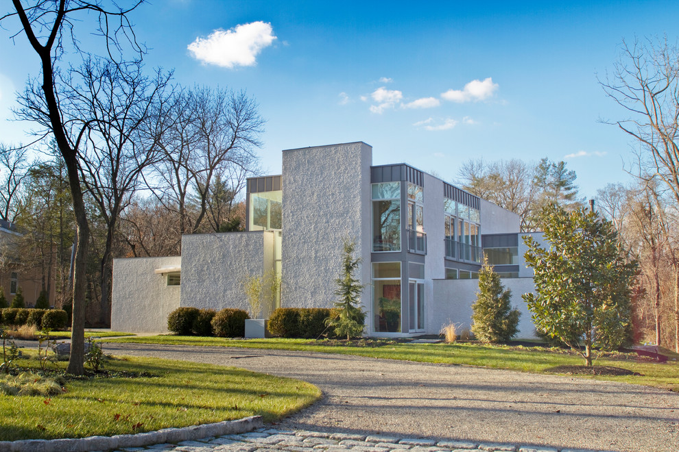 Großes, Zweistöckiges Modernes Einfamilienhaus mit Putzfassade, weißer Fassadenfarbe, Flachdach, Misch-Dachdeckung und grauem Dach in New York