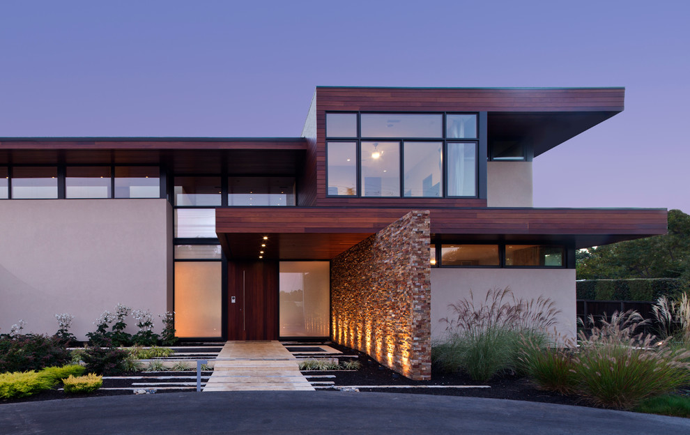 Идея дизайна: двухэтажный, бежевый, большой дом в современном стиле с комбинированной облицовкой и плоской крышей
