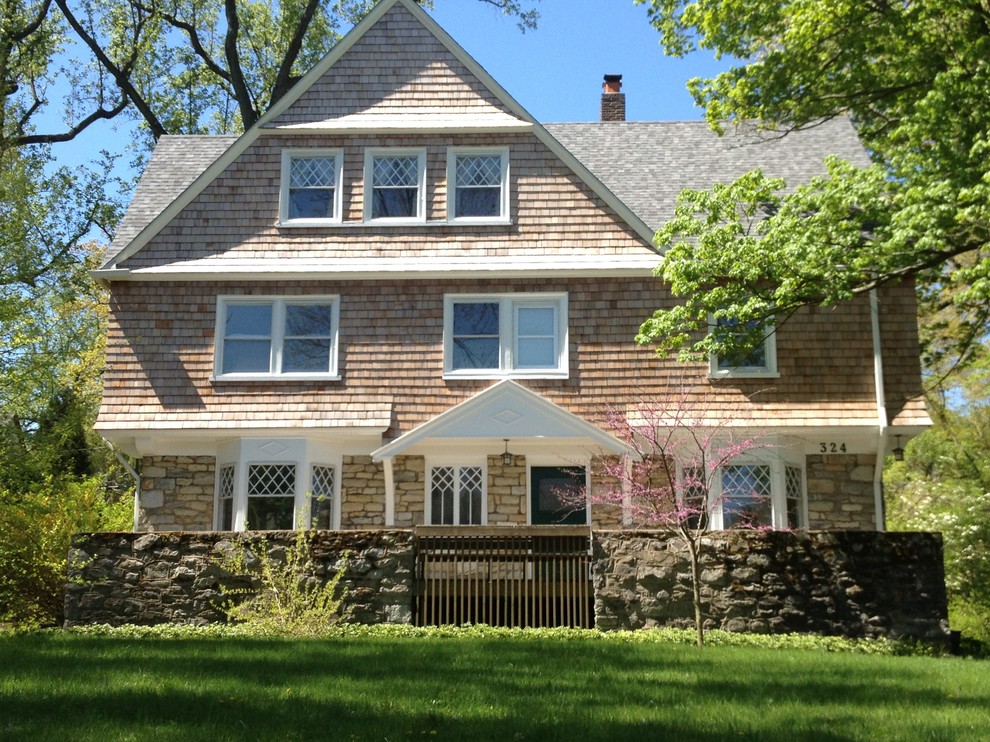Photo of a medium sized and beige traditional two floor house exterior in Philadelphia with wood cladding and a hip roof.