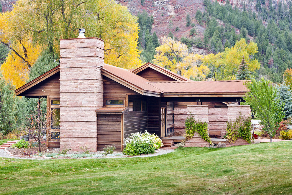 Mountain style wood exterior home photo in Other