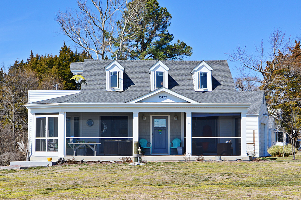 Photo of a medium sized and white nautical house exterior in DC Metro with vinyl cladding and a pitched roof.