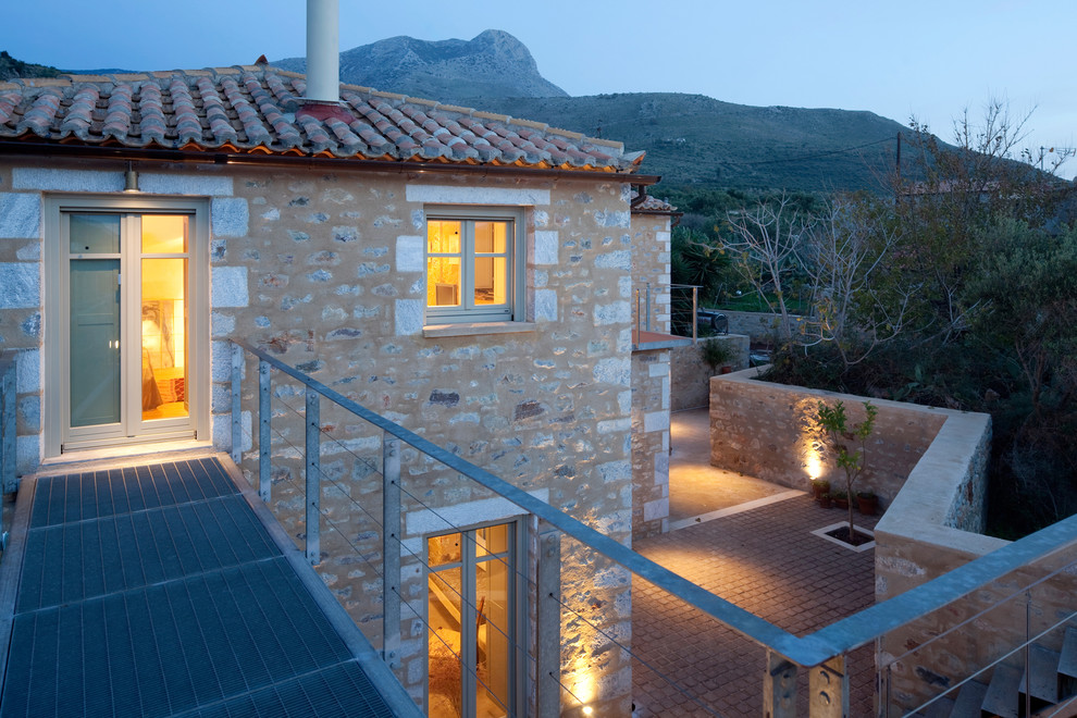 Идея дизайна: дом в средиземноморском стиле с облицовкой из камня