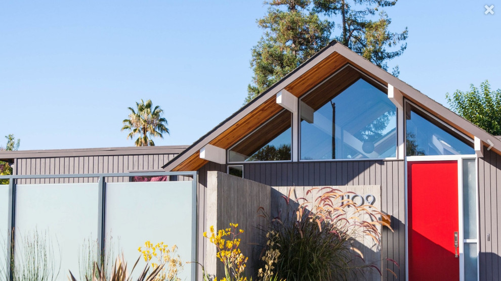 Example of a large mid-century modern gray wood house exterior design in San Francisco