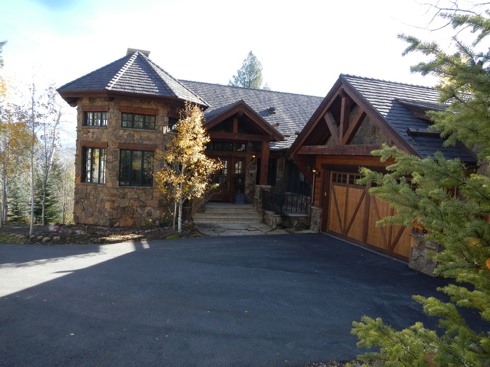 Large mountain style two-story stone gable roof photo in Denver