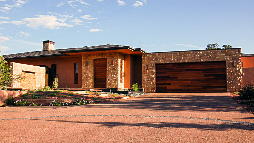 Photo of a large and beige contemporary bungalow house exterior in Phoenix with stone cladding.