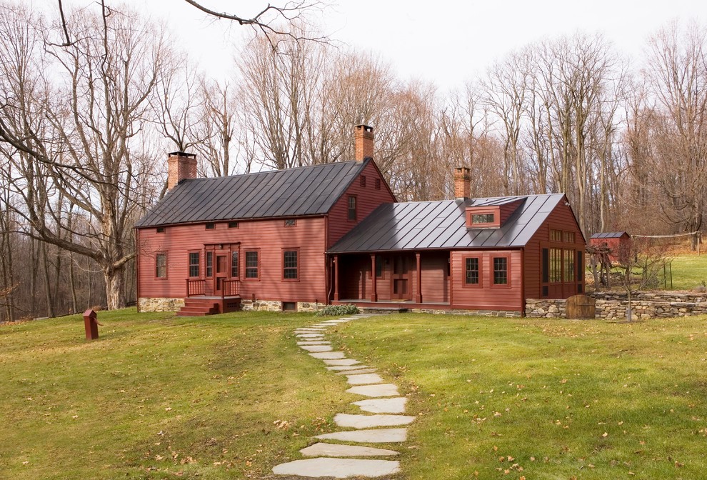 Foto della facciata di una casa rossa country a due piani con tetto a capanna