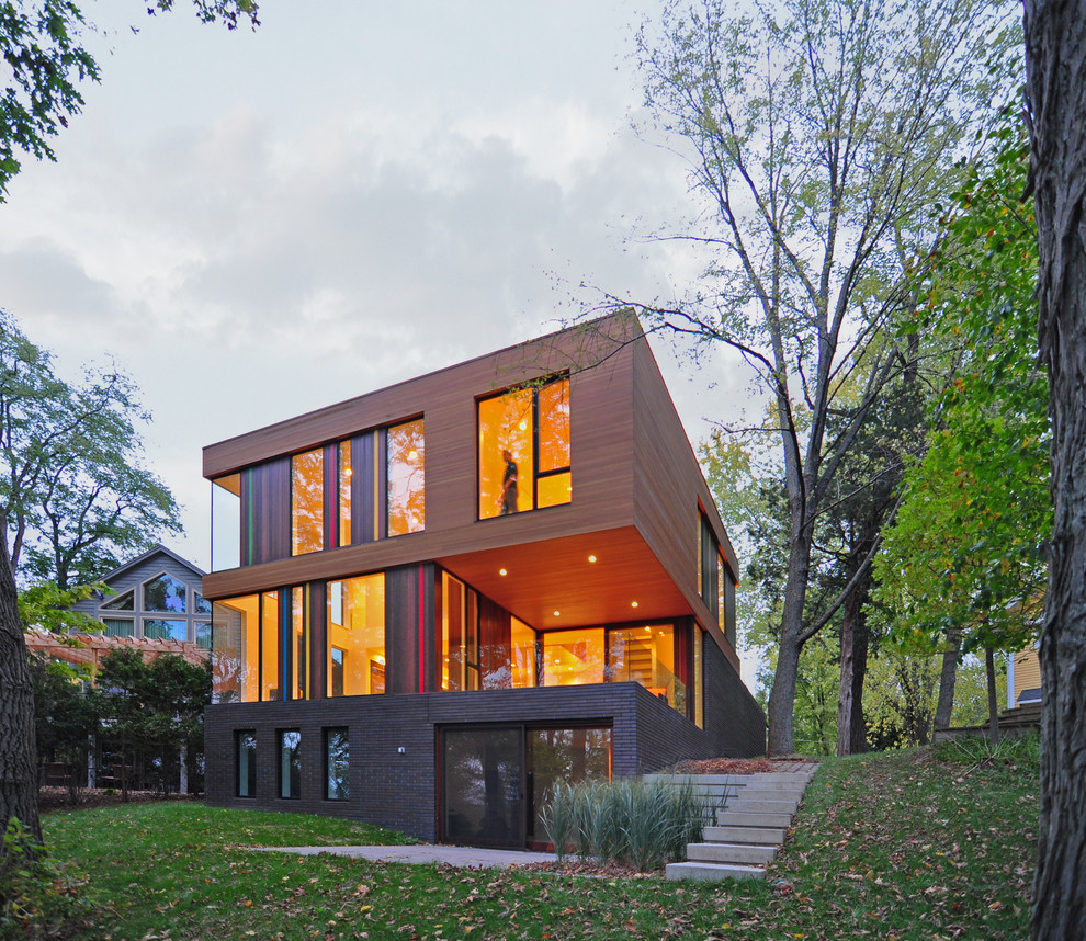 Contemporary house exterior in Milwaukee with three floors, wood cladding and a flat roof.