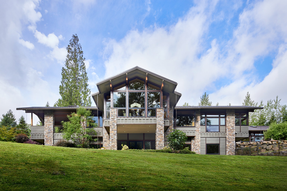 Large mountain style multicolored two-story mixed siding house exterior photo in Seattle with a metal roof