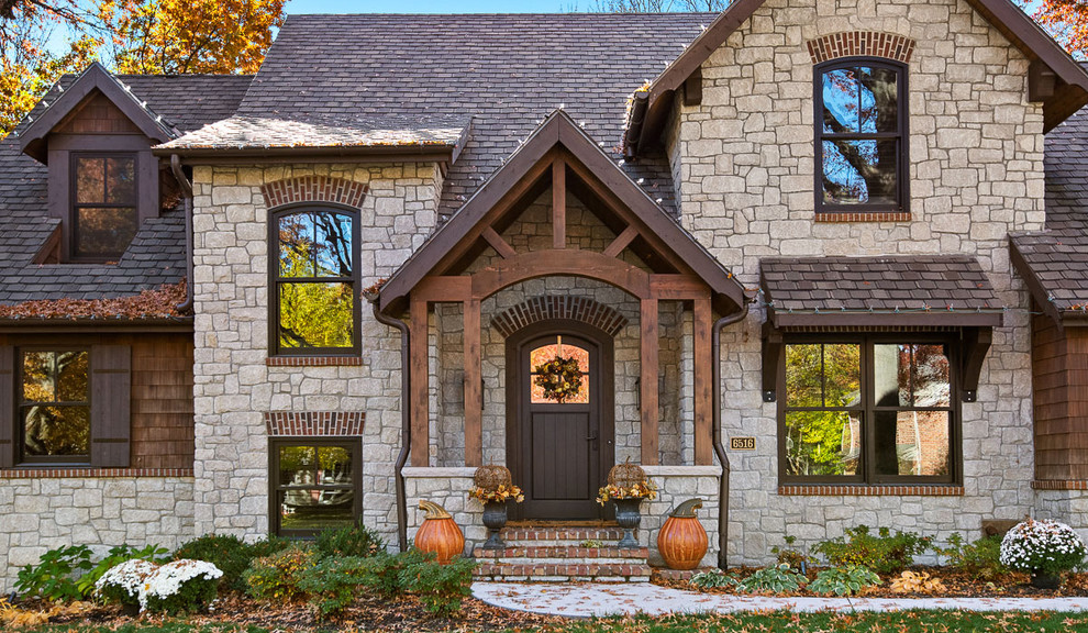 Craftsman brown two-story mixed siding house exterior idea in Kansas City with a hip roof