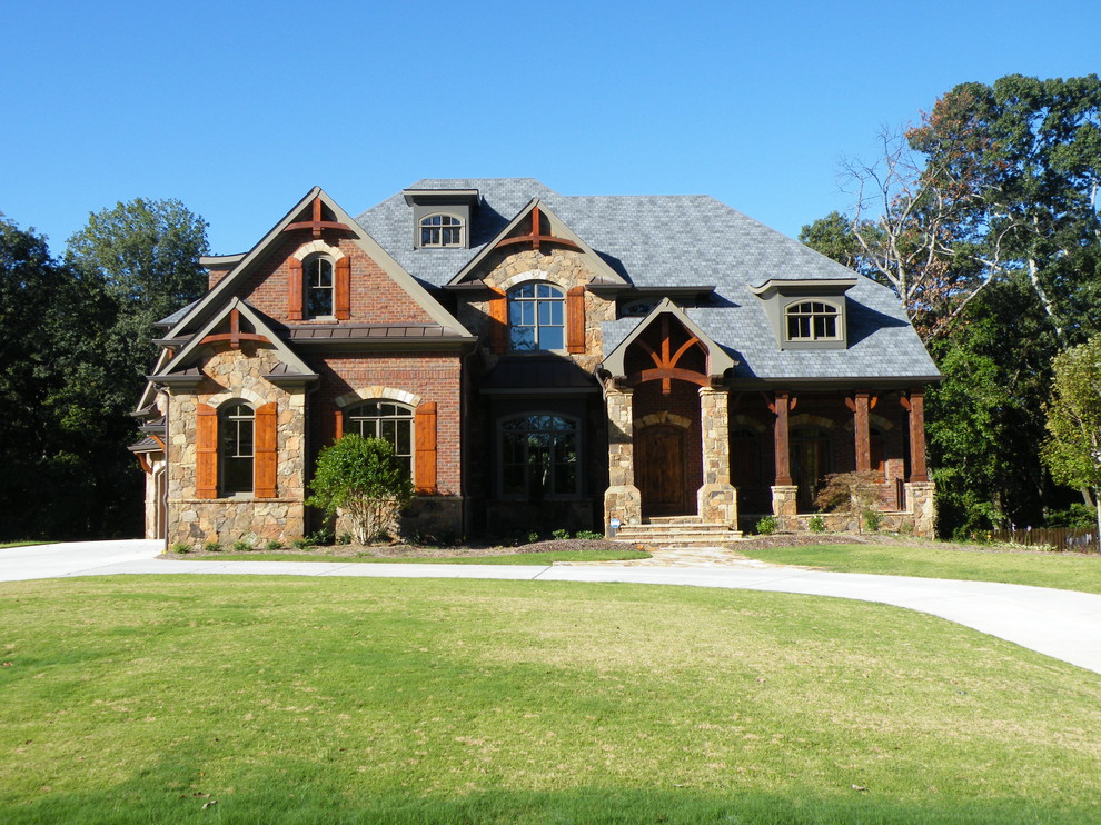 Inspiration for a large rustic brown three-story stone exterior home remodel in Atlanta